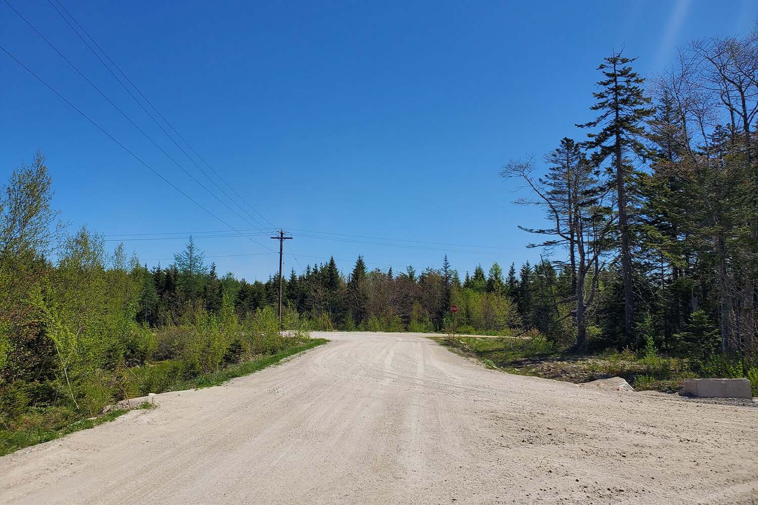 The graded, gravel road that leads to the main public road